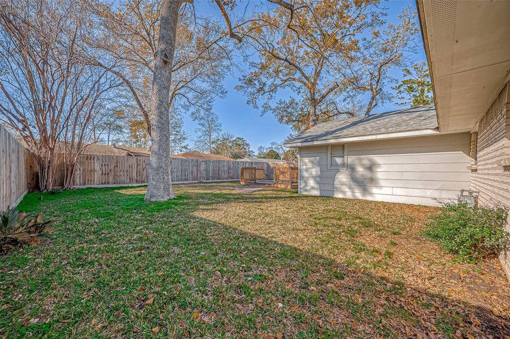 Spacious backyard with mature trees and oversized deck!