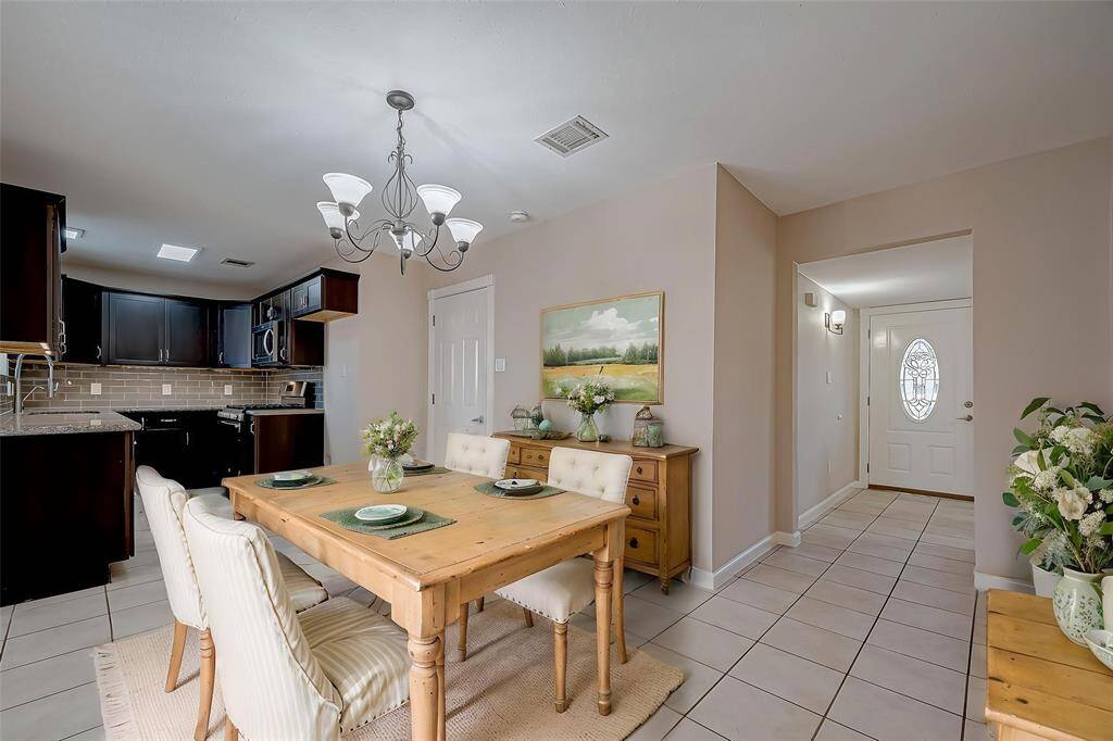 A separate breakfast area flows easily into the living area in this open-concept home. Stainless steel refrigerator, not shown, IS included. *Virtually Staged*