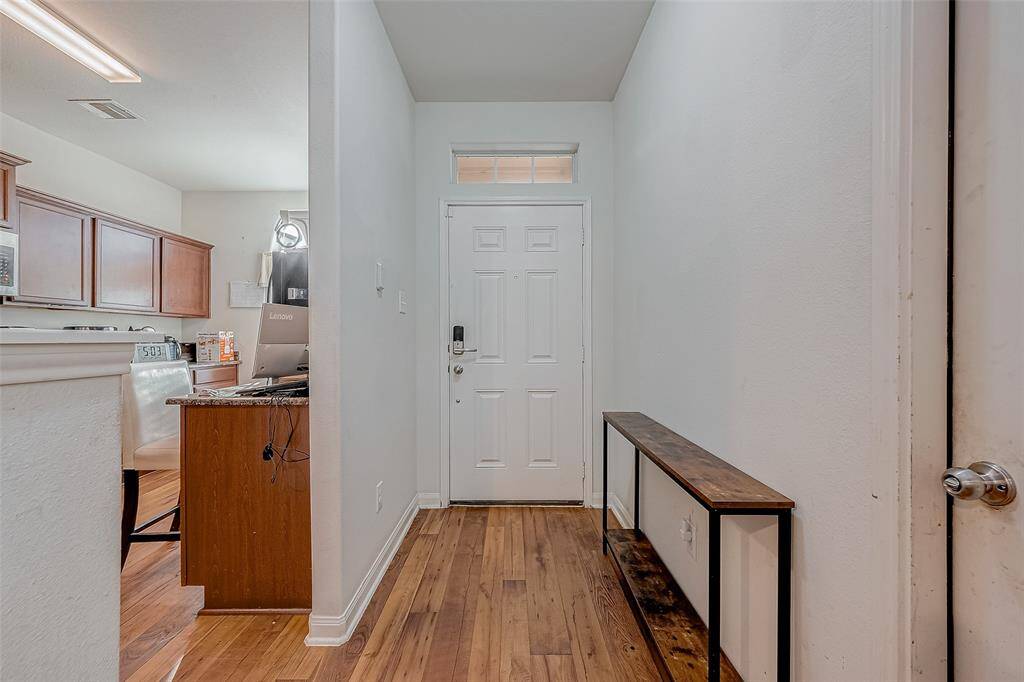 Inside and into the entryway, the kitchen sits conveniently to the right, while a direct line of sight to the living room beyond welcomes you to the main living spaces.