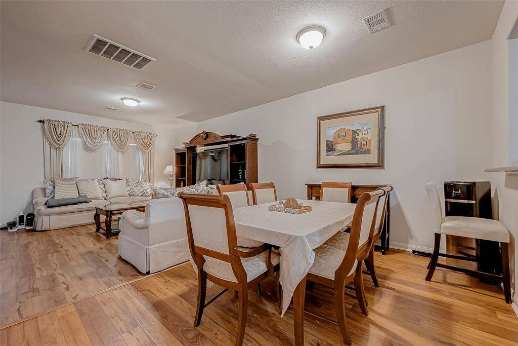 Perfectly situated between the living room and kitchen, the dining area benefits from the open-concept design while maintaining its own defined space. A conveniently placed half bath sits just to the left.