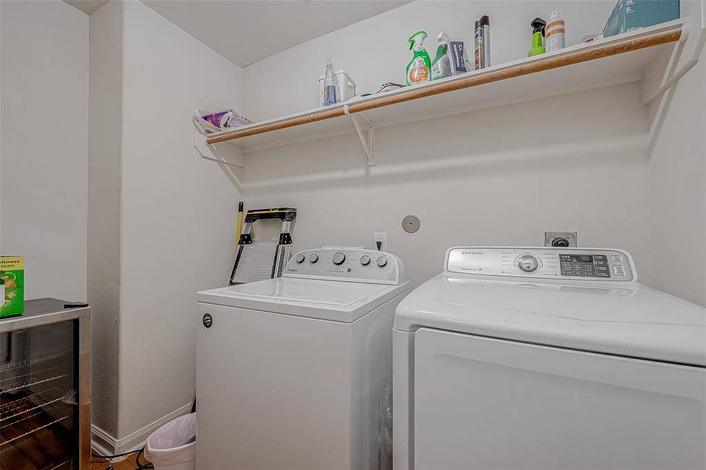 A dedicated laundry space offers plenty of room for a washer and dryer, complete with an overhead rack for convenient storage.
