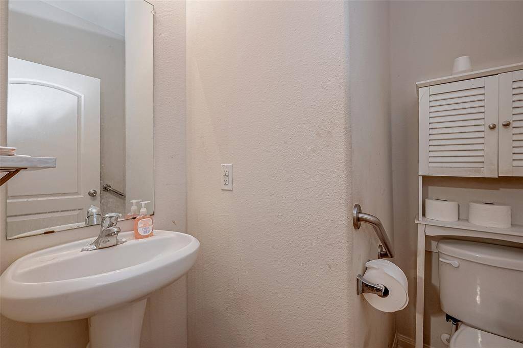 A well-placed half bathroom with all the essentials ensures convenience for both residents and guests.