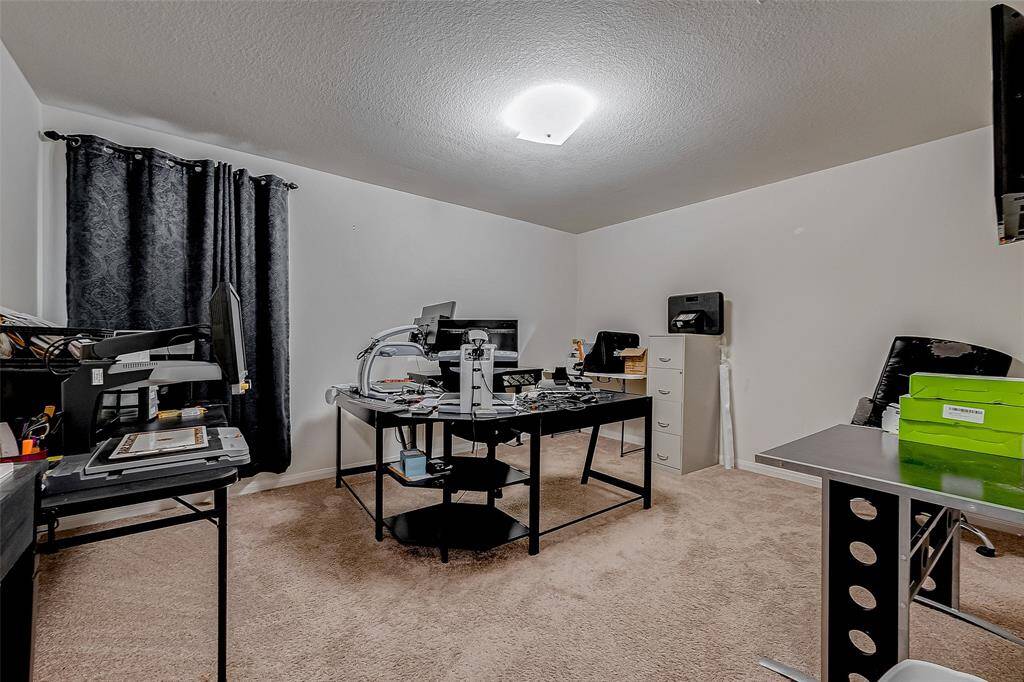 Spacious and versatile, this carpeted upstairs bedroom can serve as a comfortable sleeping space, a home office, or a creative studio.