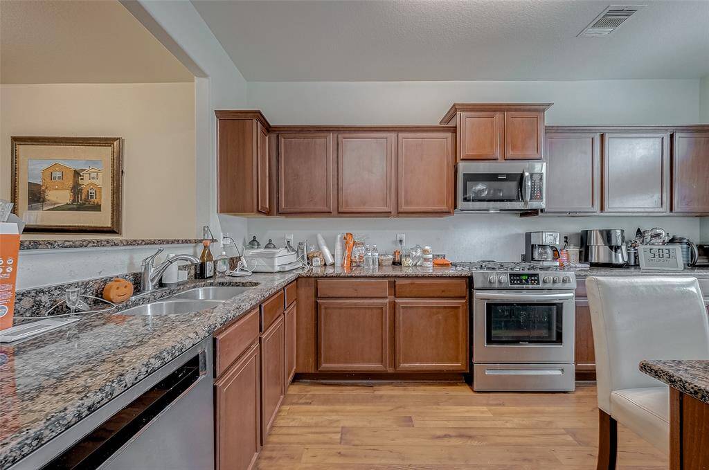With an abundance of storage both overhead and below, this kitchen is ready for everyday meals and special occasions. Its open sightlines into the surrounding spaces allow for effortless multitasking.