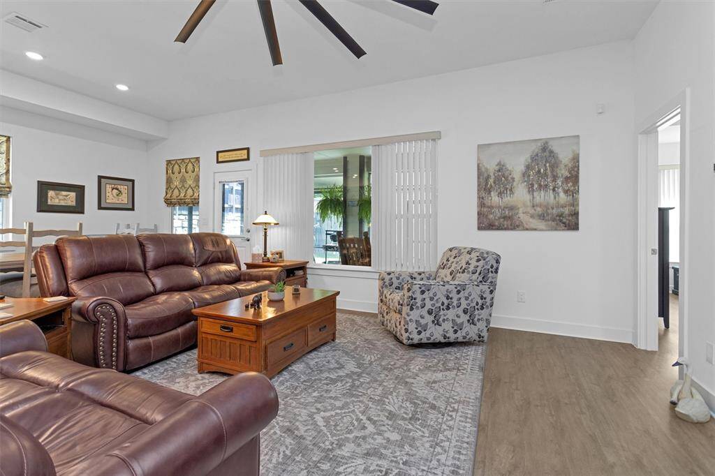Comfort meets elegance in the open-concept living room, where natural light pours in through large windows and the airy layout invites relaxation. Whether you're enjoying a quiet evening or entertaining a crowd, this space offers warmth, flow, and flexibility—anchored by a central gathering area that’s perfect for any occasion.