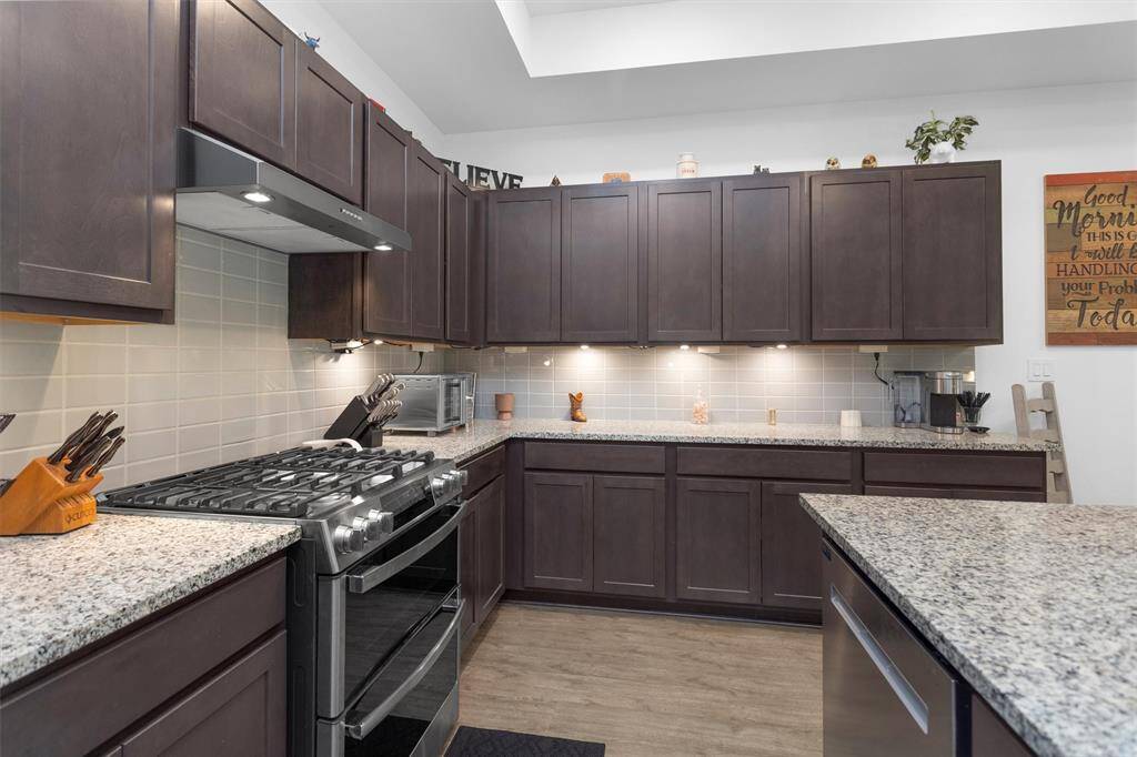 This show-stopping kitchen is the true heart of the home—designed for both everyday ease and upscale entertaining. Featuring an oversized granite island with bar seating, a custom designer vent hood, stainless steel appliances, and stylish tile backsplash, it’s as beautiful as it is functional. The massive walk-in pantry offers storage galore, keeping everything tucked away yet within reach.