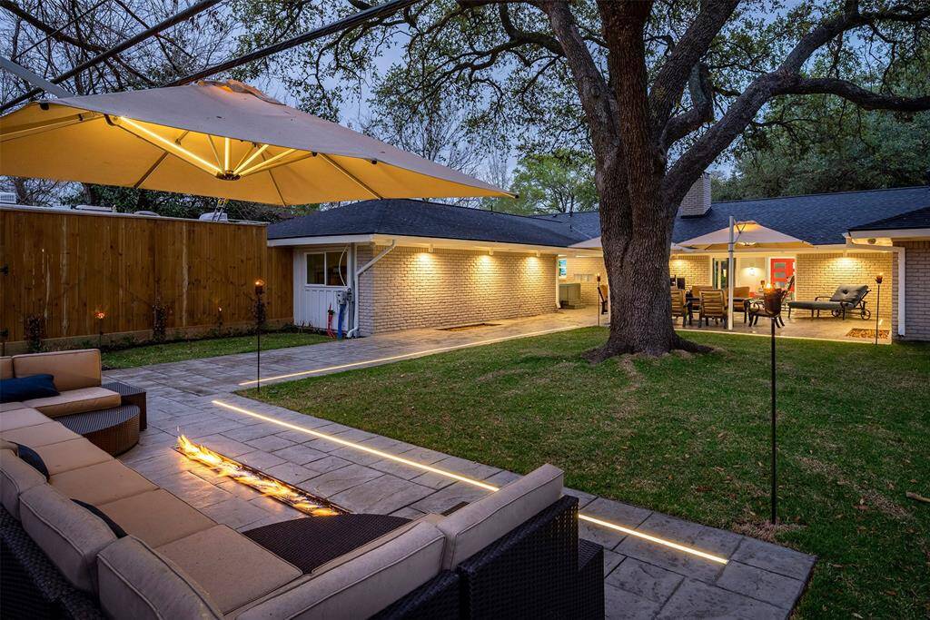 Enchanting backyard retreat shaded by majestic oaks.
