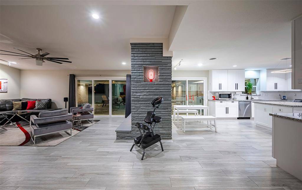 Brick fireplace separates living from kitchen