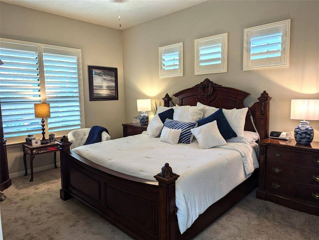 Notice the window with the plantation shutters. Ceiling fan, Sitting area by the window.