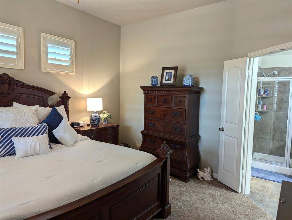 Primary bedroom with a view into the primary bath.