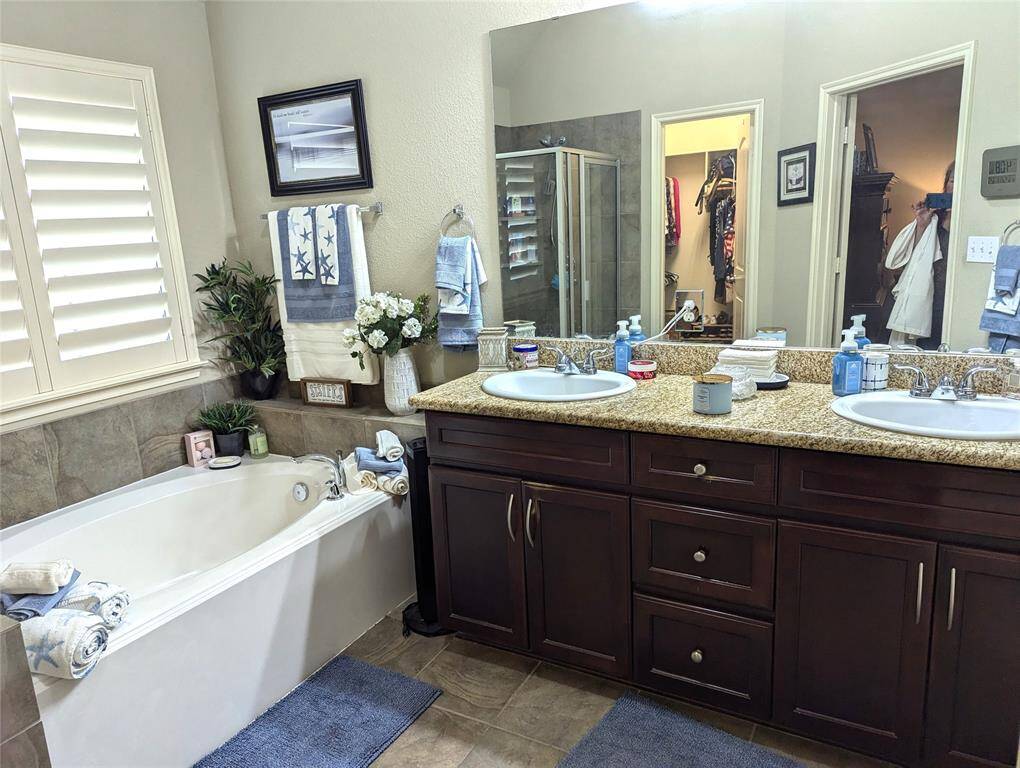 Luxury primary bath with double sinks, granite counter tops, and a separate shower. Large walk in closet.