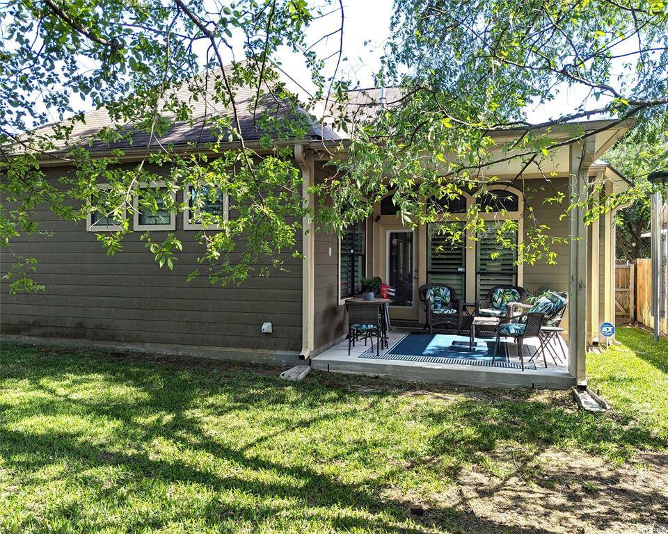 View of the back of the home. Note the gutters and downspouts, sprinkler system. Fully fenced!