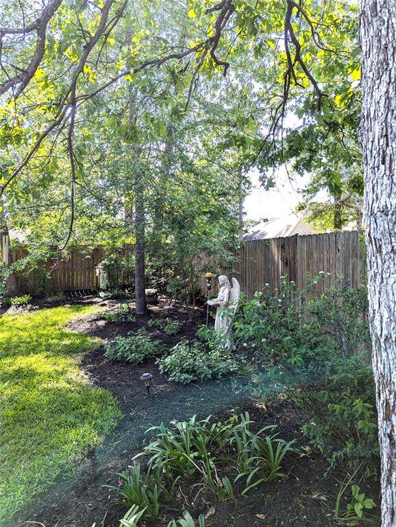 Professionally landscaped front and back! The cement bench and Angel statue stays!