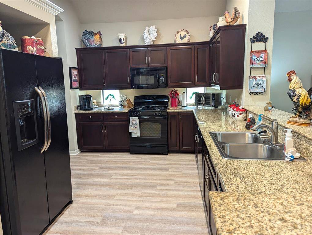 Spacious kitchen! Note the windows under the cabinets. Under cabinet lighting. View into living room.