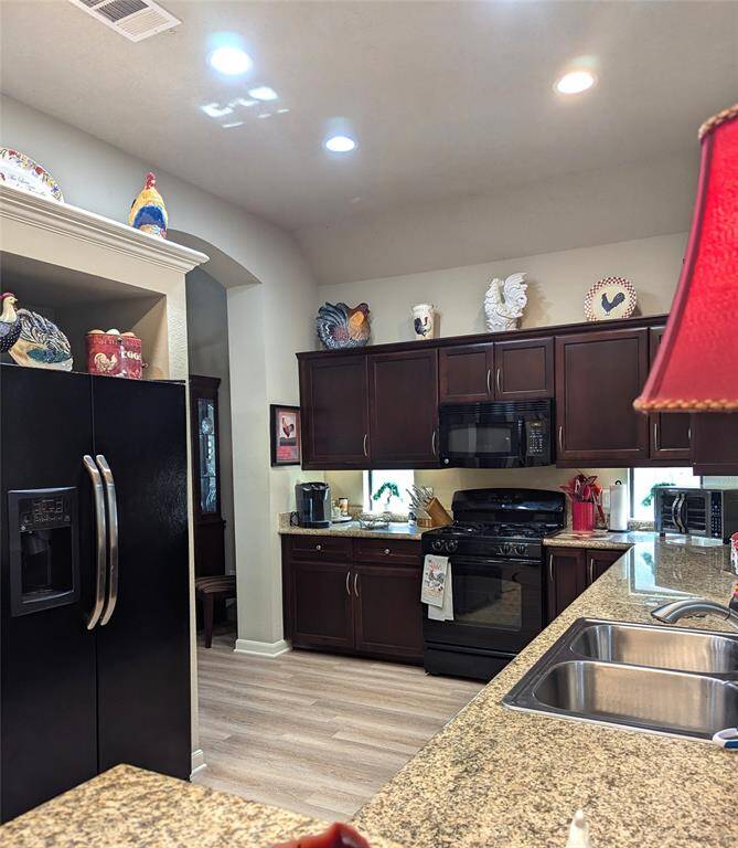 Granite countertop. Decorative niches. Stainless double sinks.
