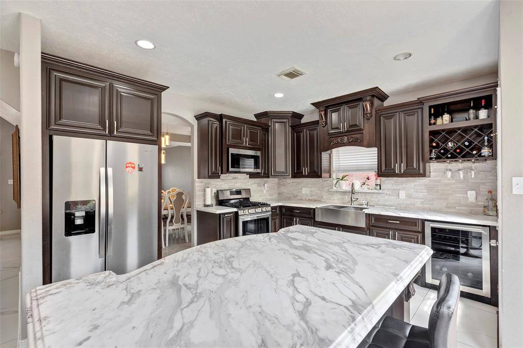 Kitchen with beverage cooler and wine rack