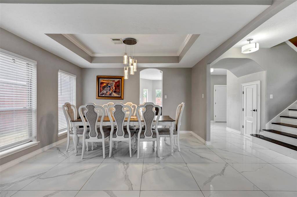 Formal Dining with tray ceilings and crown molding
