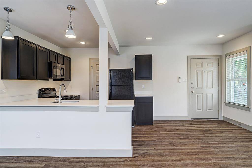 LARGEST Fourplex - Open Living and kitchen space, with lots of room for entertaining and tons of counter space and room to add stools for seating. Pictured to the left of the fridge - large pantry!...
