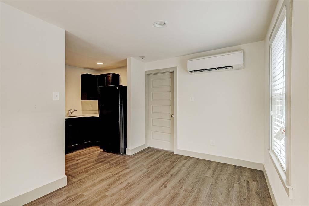 SMALLER FOURPLEX -Partial view of kitchen and bedroom door