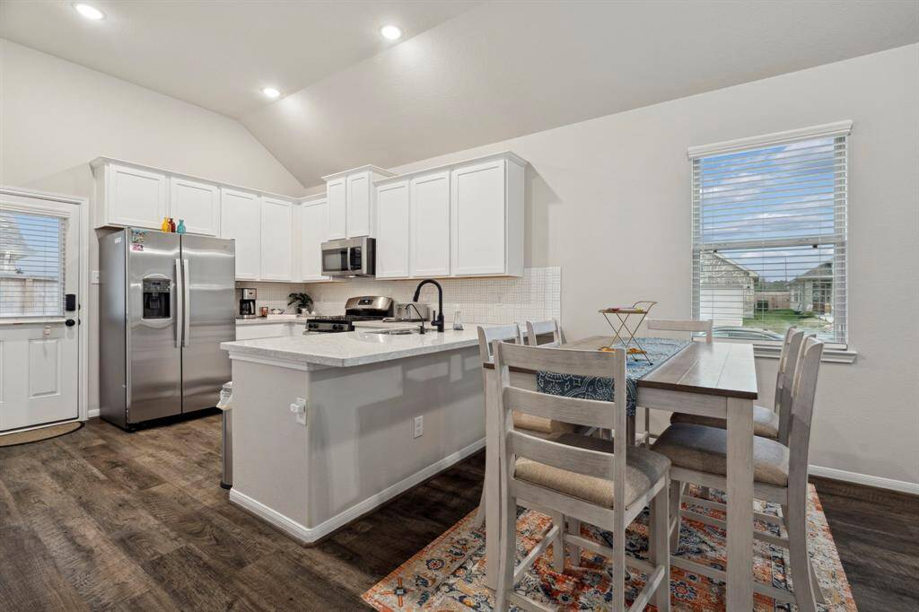 Kitchen seamlessly flows into the living room, which is spacious and bright, offering plenty of room for both relaxation and entertainment.