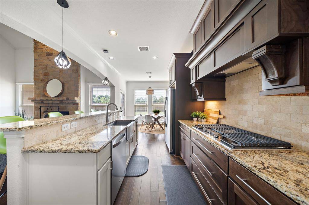 Neutral Granite countertops and stainless appliances.