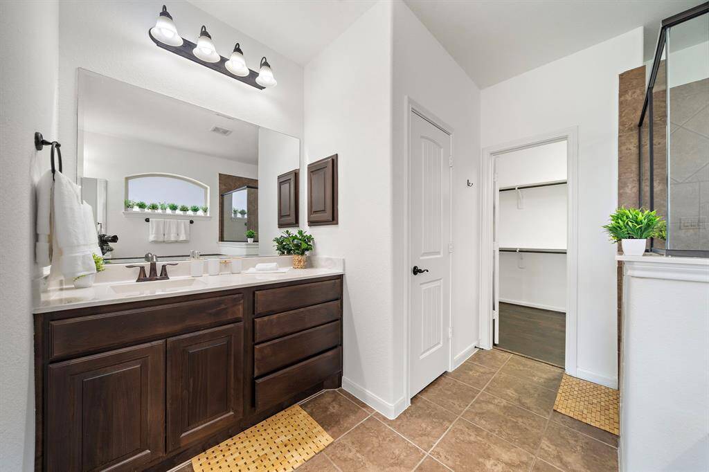 Dual vanities with lots of storage space in the primary bath.
