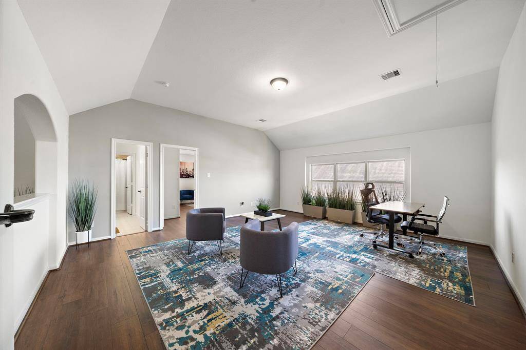 Spacious gameroom upstairs with wood flooring as well.