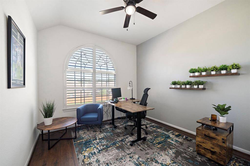 Bedroom 5 upstairs also features hardwood floors, ceiling fan and plantation shutters.