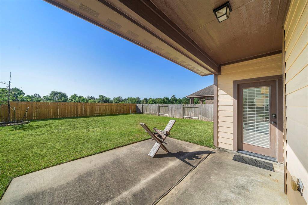Covered back patio overlooks your private backyard.
