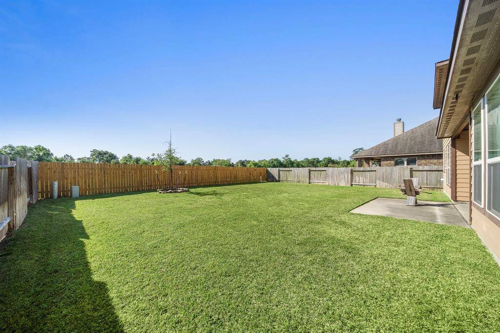 Spacious backyard with access to walk trails behind.