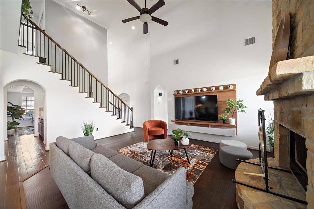 Wrought iron railing flanks the open stairway.