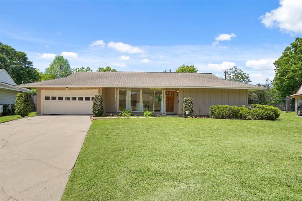 The Double Wide Driveway leads to a 2 Car Attached Garage in this Charmer! The Garage features Finished Sheetrocked Walls, Workbench, and a Water Heater Raised on a Platform. A Door with Micro Mini Blind Insert opens from the Garage to the Park-Like Yard and Patio Area. Per Seller, the Chest Freezer in the Garage remains with the House.