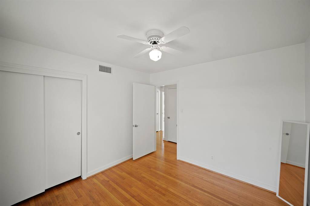 Additional Features in the Second Bedroom include Oak Hardwood Floors, Fresh White Designer Paint, and a Closet with Hanging Rod, Built in Shelf, and 2 Panel Door Enclosure.