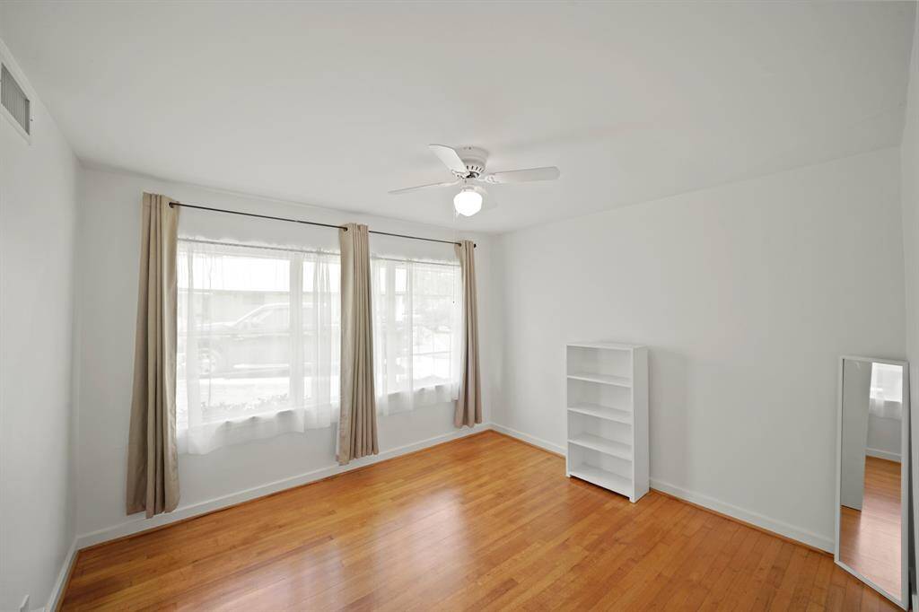The Third Bedroom offers Windows that view the Side Yard, Grey Linen Style Tab Drapes, and White Sheers.
