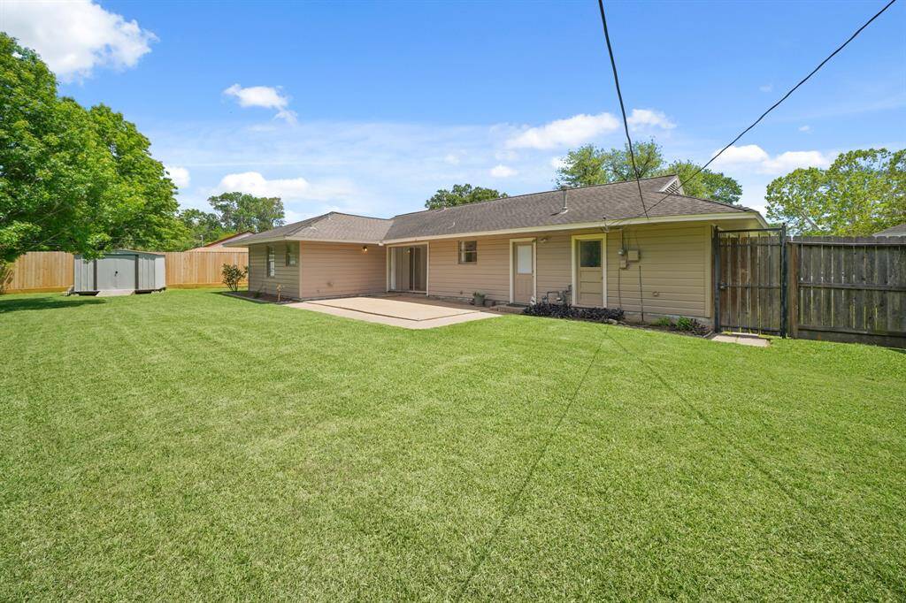 The House boasts an Expansive Concrete Patio (Approximately 24'6" x 16'6") with Plenty of Space for Outdoor Furniture and a BBQ Grill.  A Wood and Wrought Iron Gate leads from the Backyard to the South Side of the Home leading to the Front Yard.  A Concrete Paver Walkway is located from the Back Patio to the Wood and Wrought Iron Gate.