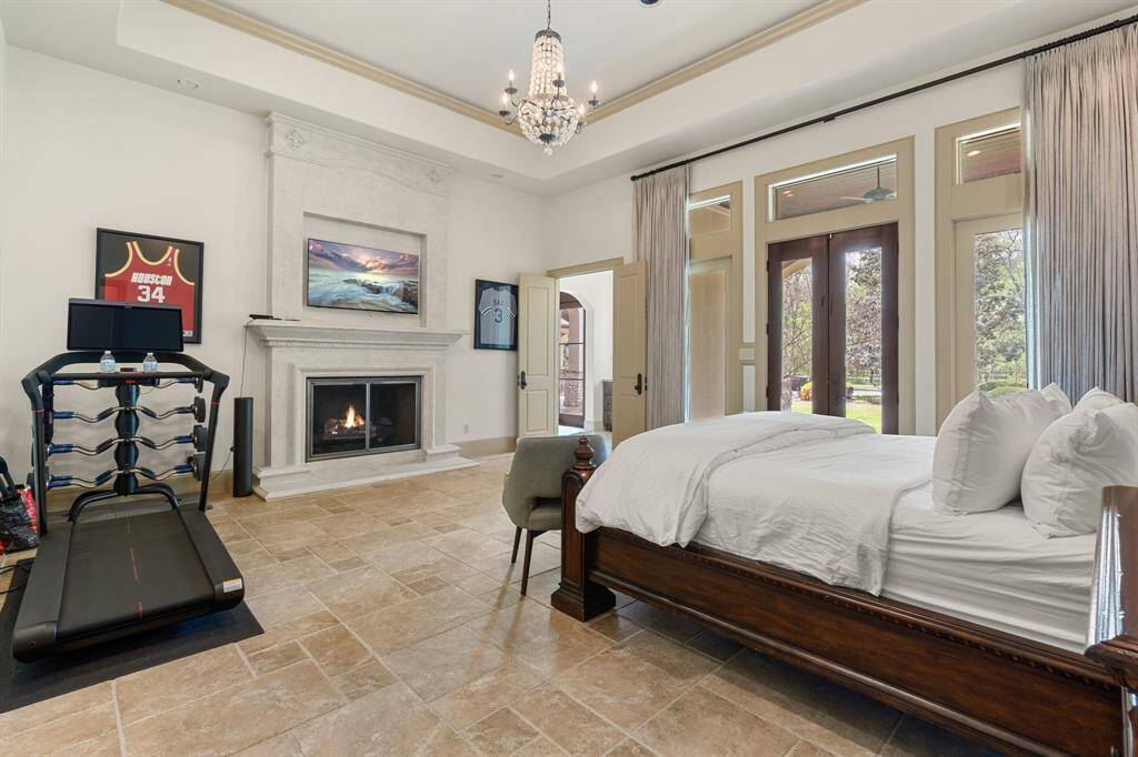 In this luxurious master bedroom, the fireplace serves as more than just a source of warmth—it's a symbol of comfort, elegance, and timeless sophistication, creating a sanctuary where you can escape the stresses of everyday life and indulge in the simple pleasures of home.
