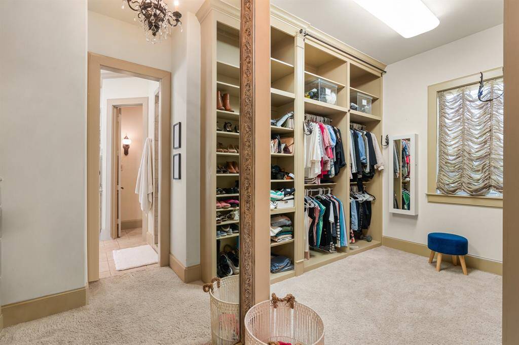 Welcome to the spacious walk-in closet, a luxurious haven of organization and style that offers ample room to store and showcase your wardrobe collection.