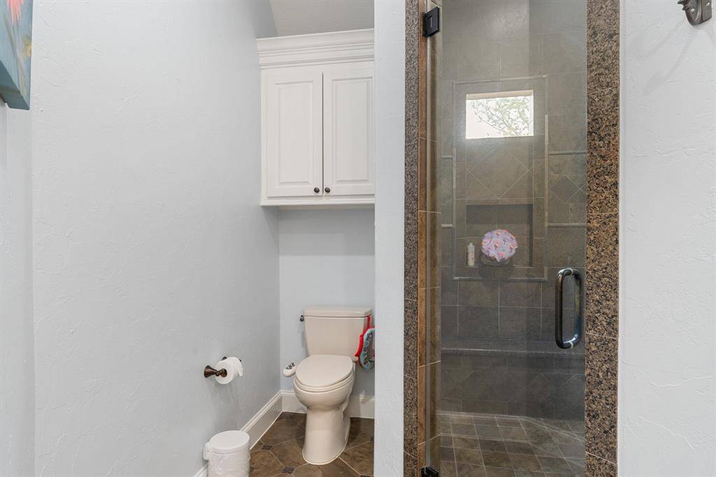 Adjacent to the bookshelf, a door opens to reveal a private oasis: the nursery's very own bathroom.