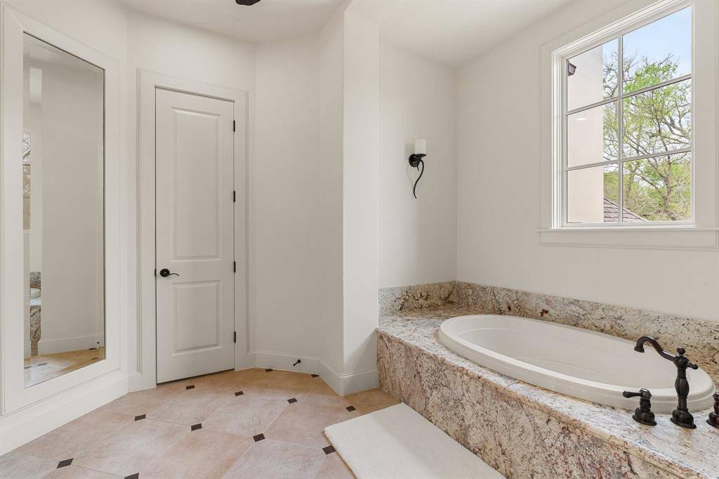 Step into the luxurious bathroom, where a lavish bathtub awaits, promising moments of relaxation and indulgence.