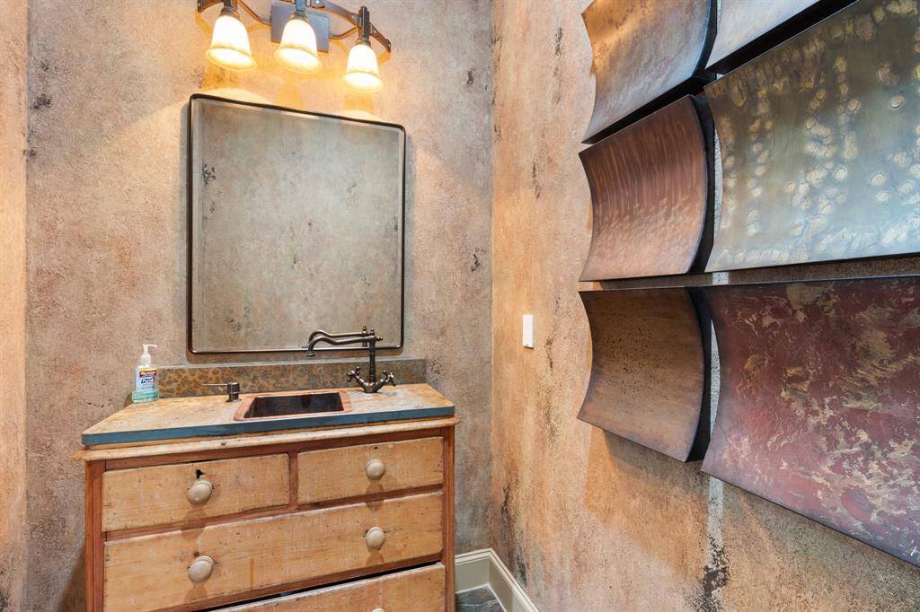 To further enhance the rustic charm of the powder room, consider adding accents such as wrought iron towel hooks, vintage-inspired light fixtures, and handcrafted pottery accessories.