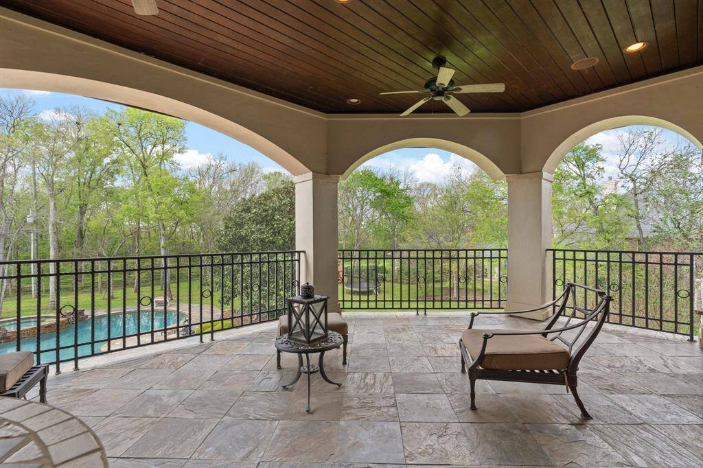 In this idyllic outdoor retreat, the covered balcony with its pool view offers a seamless blend of comfort, elegance, and natural beauty, creating a sanctuary where you can escape the stresses of everyday life and reconnect with the peaceful rhythms of nature.