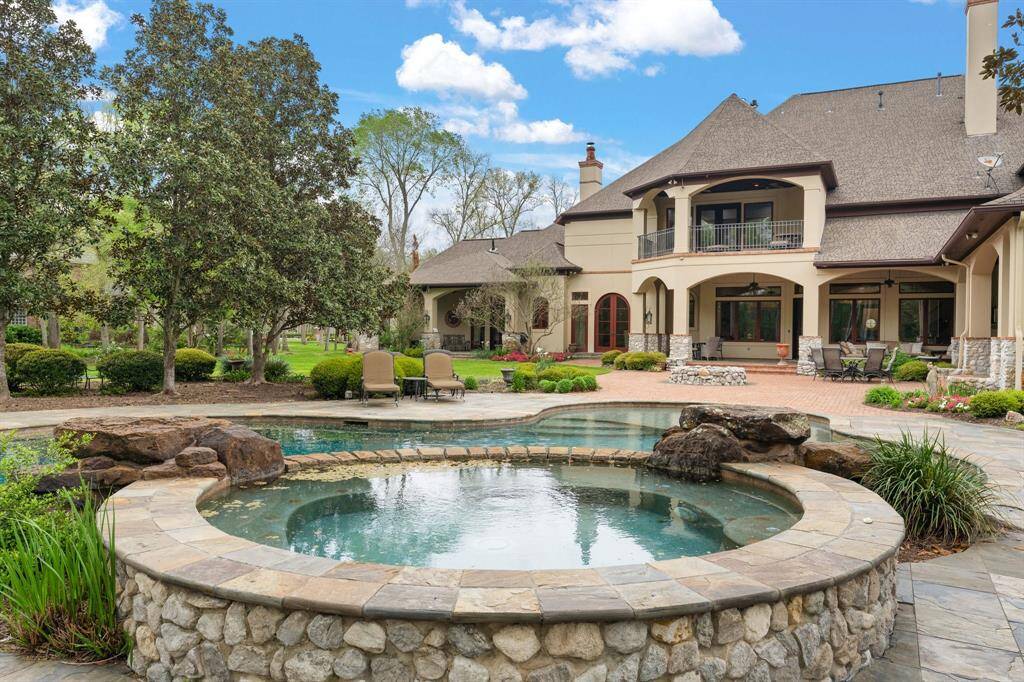 The pool is a serene oasis, beckoning with crystal-clear waters and surrounded by lush greenery, creating a tranquil retreat for relaxation and leisure.