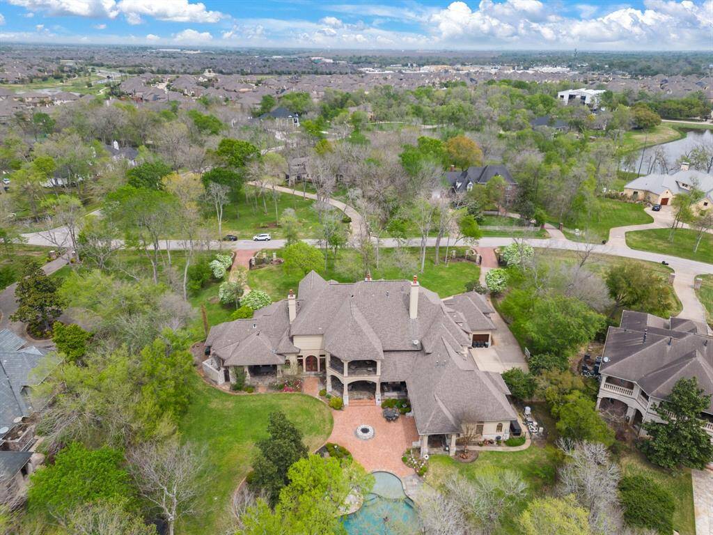 This unique gem is nestled on 1.5 acres within a serene community in Fort Bend County.