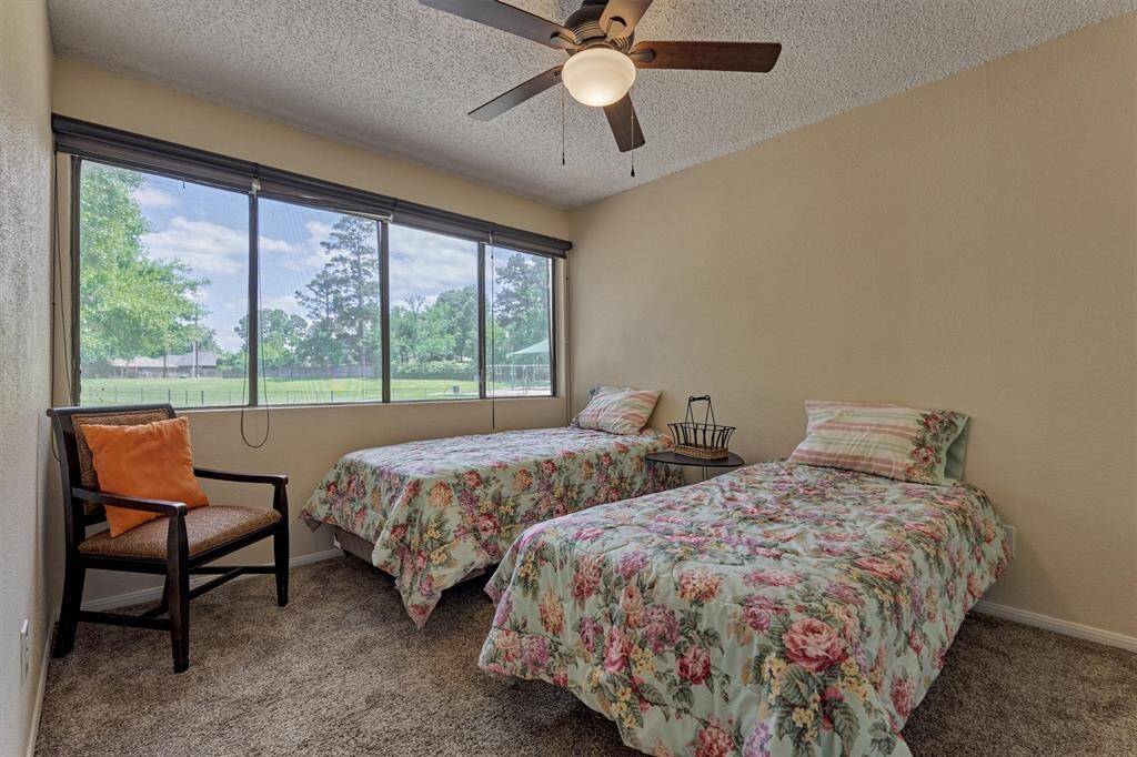 The guest bedroom has a walk in closet, can easily accommodate two twin beds and overlooks the community park and green space.