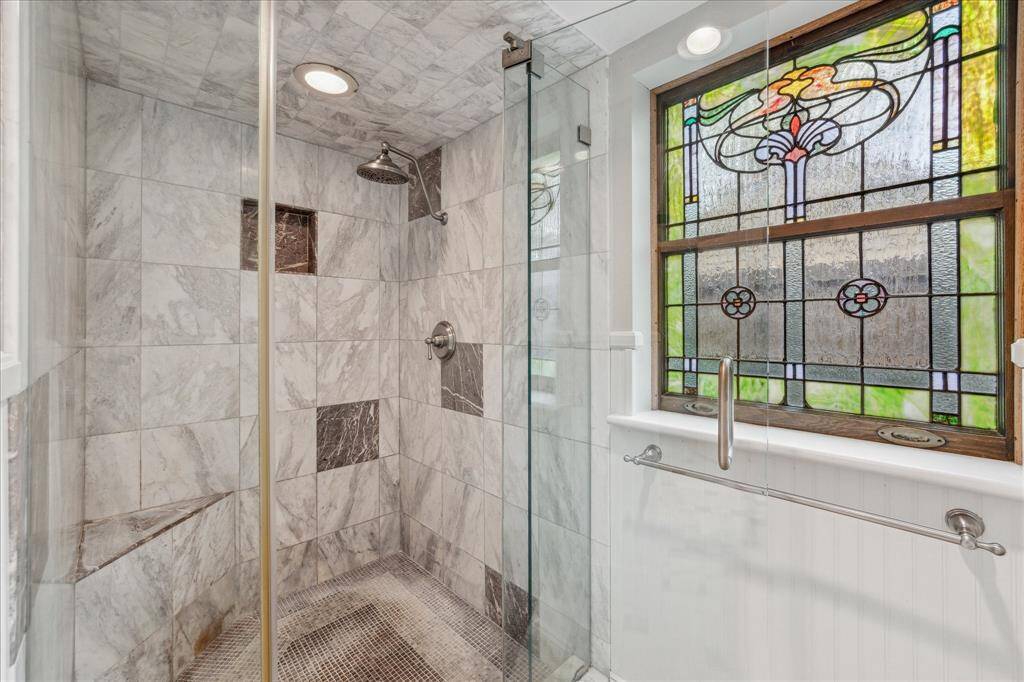 Primary shower with bench.  The primary suite also offers a large walk-in closet.