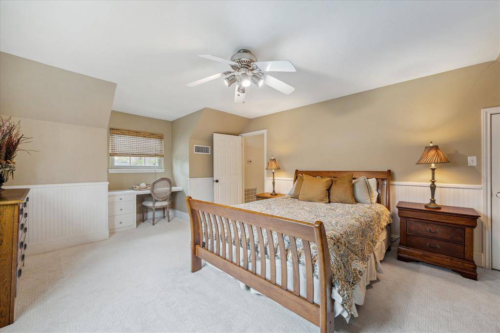 Upstairs secondary bedroom with 2025 carpet, large closet and built-in desk