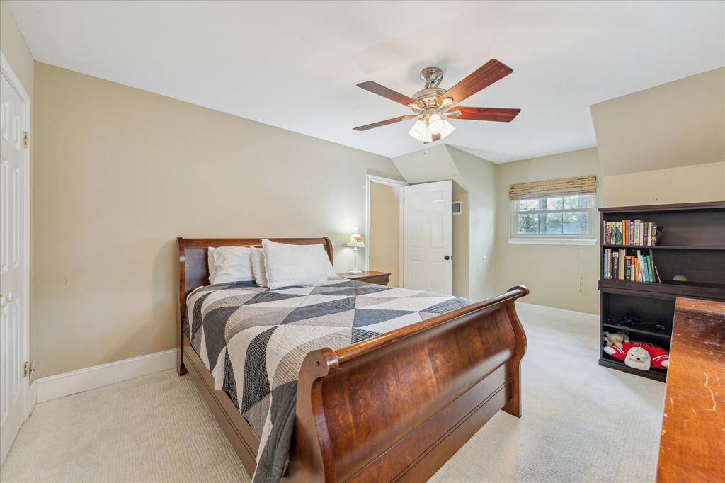 Third secondary upstairs bedroom with dual closets and 2025 carpet