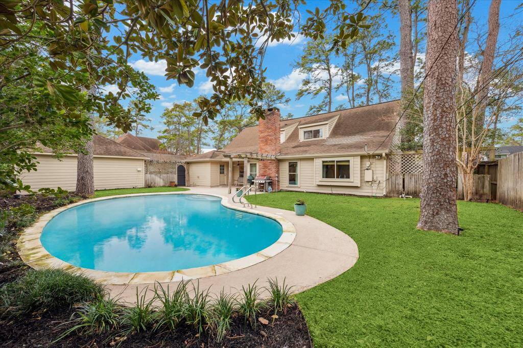 Sparkling pool plus a yard in this inviting backyard