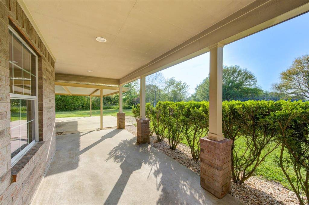 Covered Front Porch, access ramp to Carport