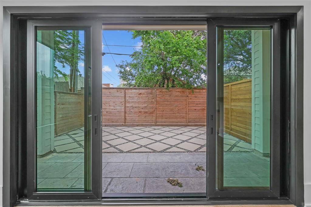 Backyard with covered patio off your first floor living room.